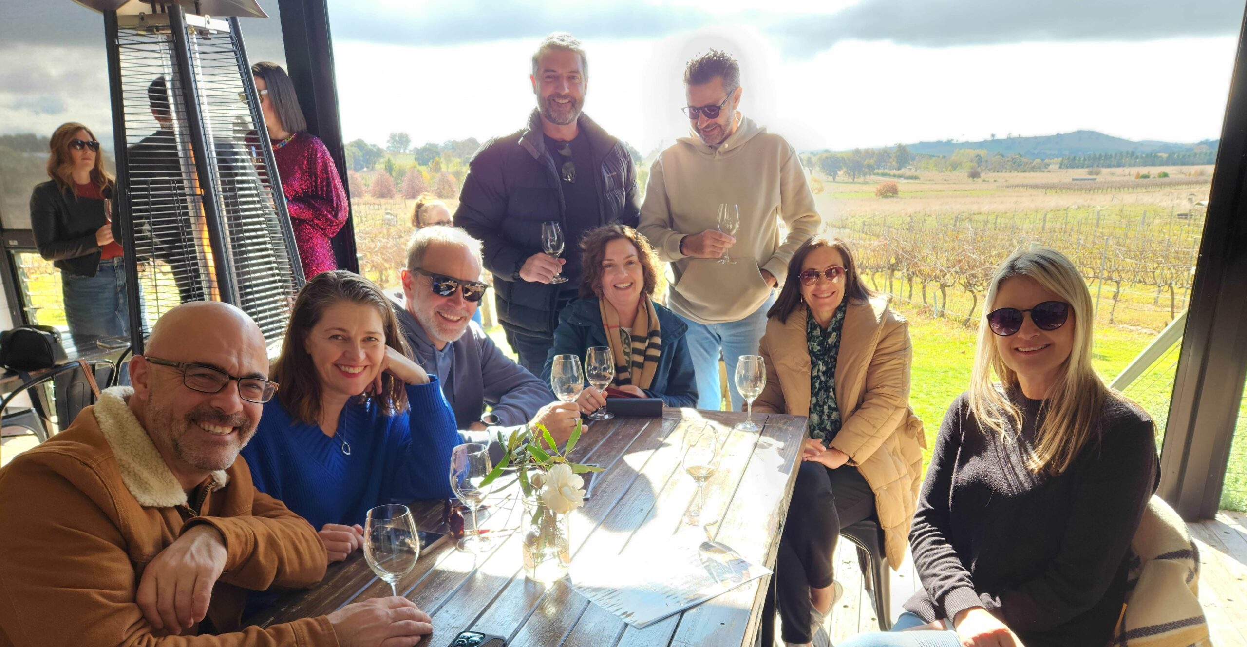 Group photo at the Vintner's Daughter with the vineyard in the background