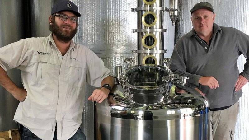 Western Australia Piscos winemakers posing inside a distillery.