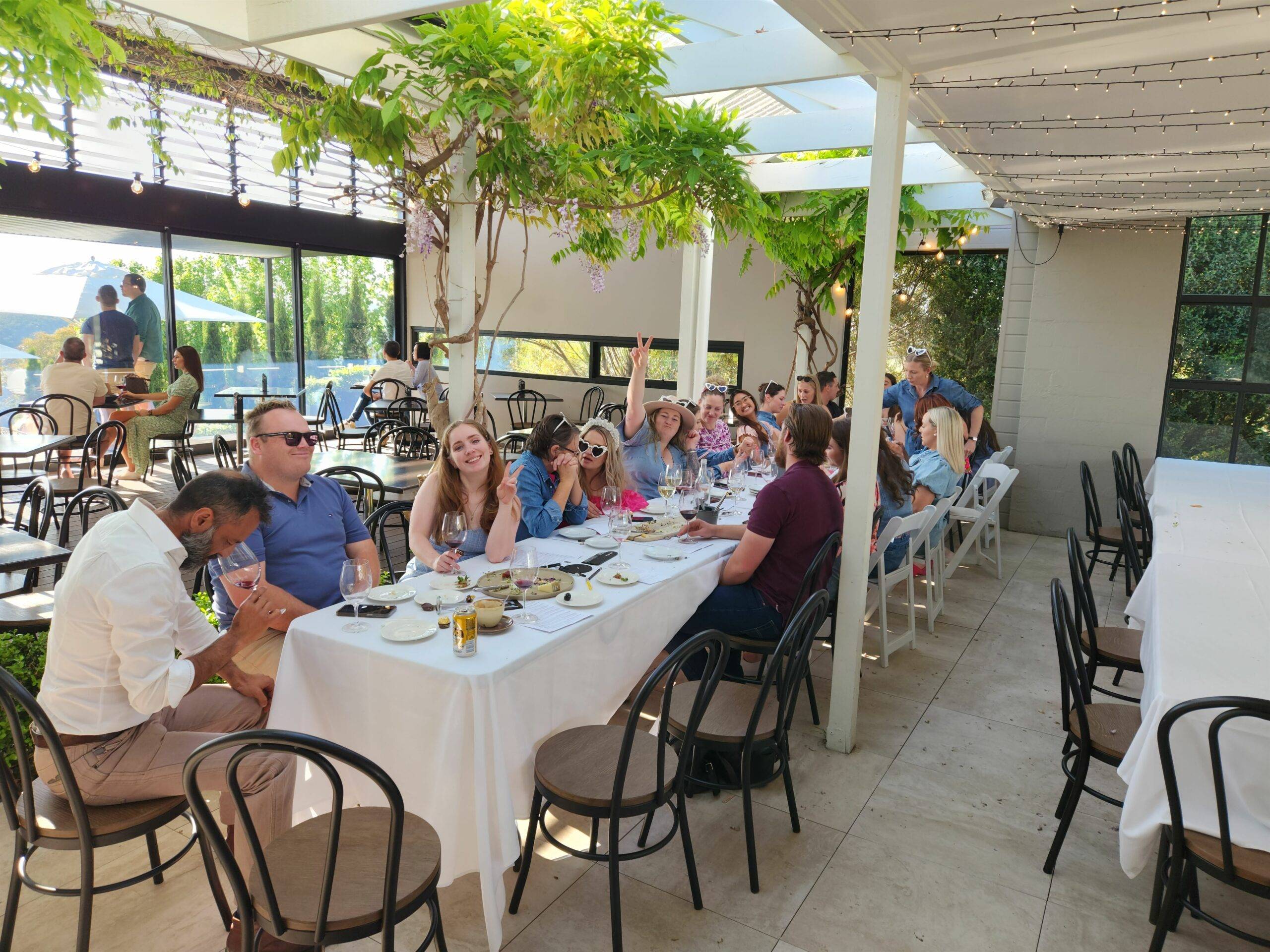 A group of individuals gathered around a table, engaged in conversation and enjoying a meal together.